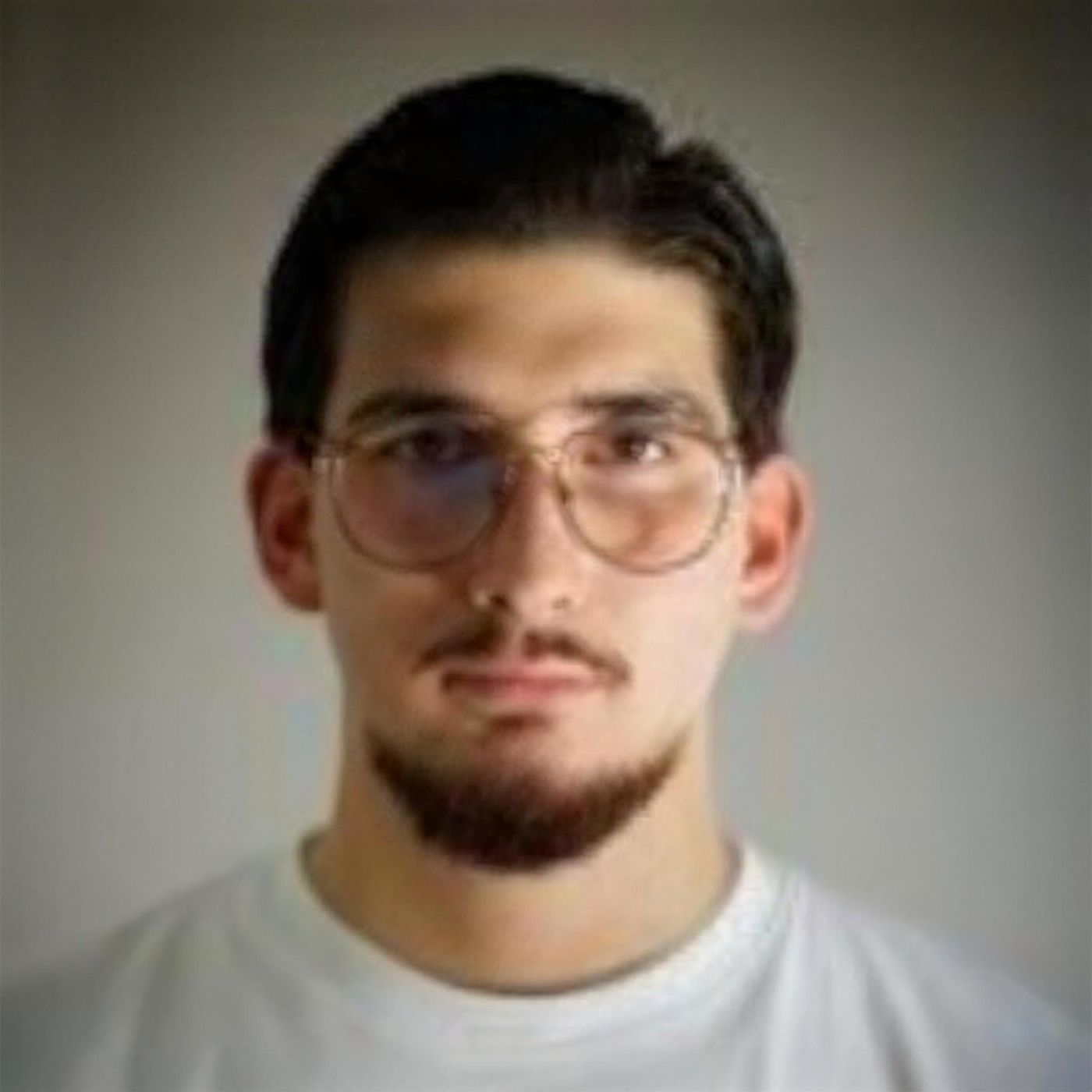 Headshot of SEYMEN wearing glasses